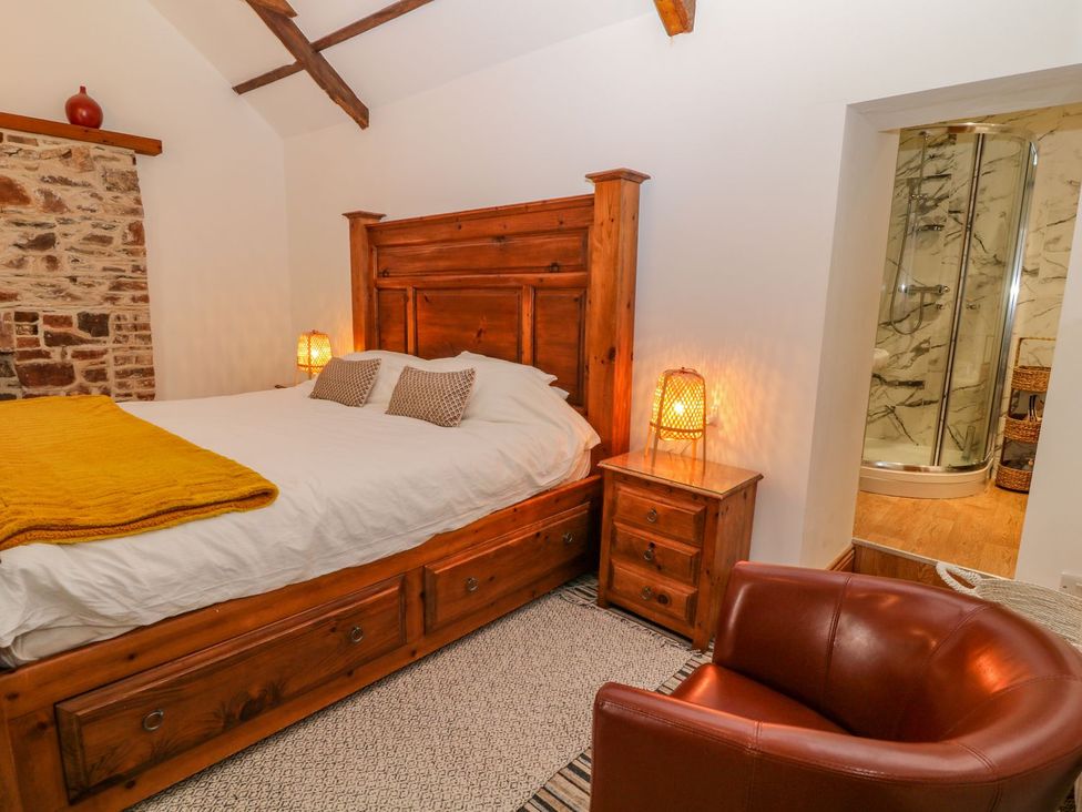 A bedroom with a bed and shower in Baywatch (St. David's View) Lynton