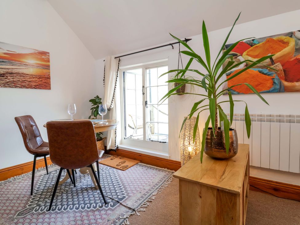 A dining room with a table and chairs at Baywatch (St. David's View) Lynton