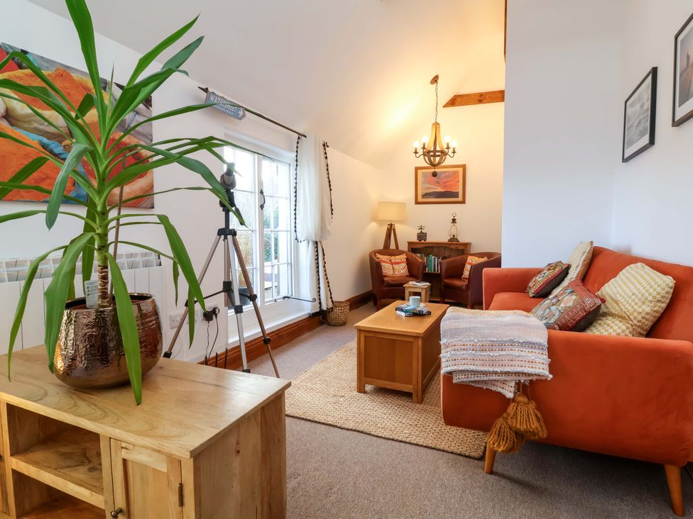 A living room with a plant and a sofa at Baywatch (St. David's View) Lynton