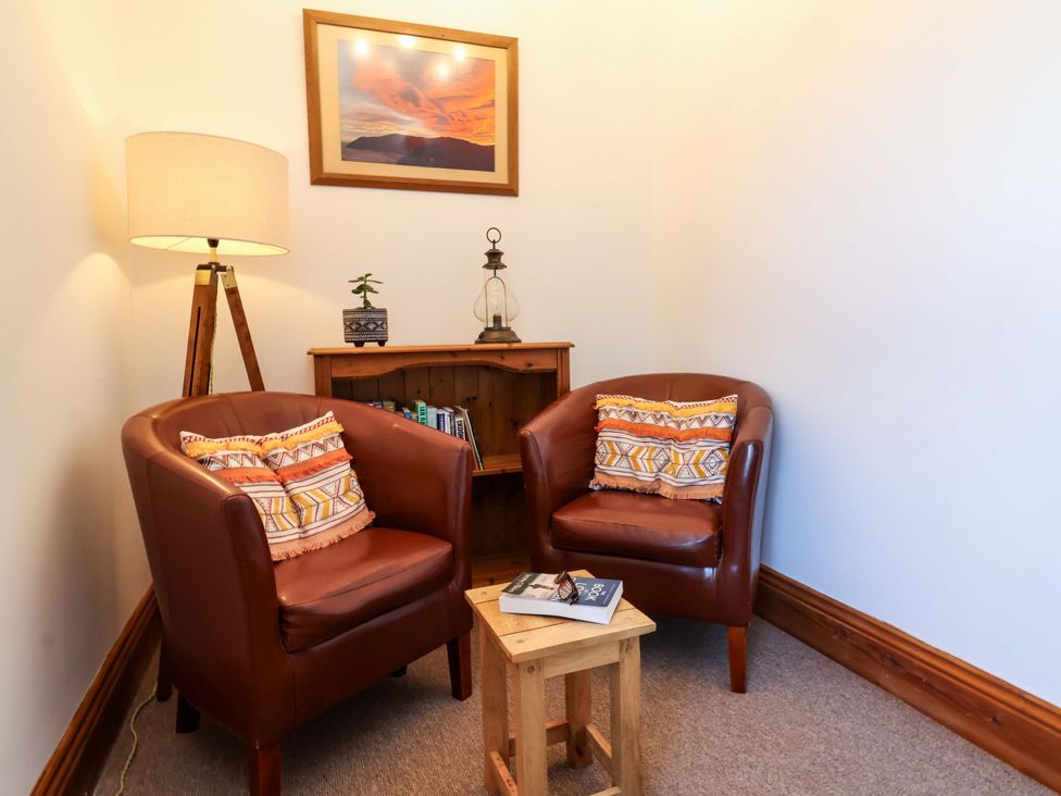 A reading nook with two armchairs and a small table at Baywatch (St. David's View) Lynton