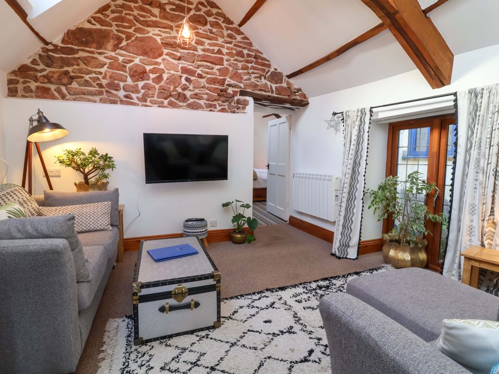A living room with a television and a sofa at Baywatch (St. David's View) in Lynton