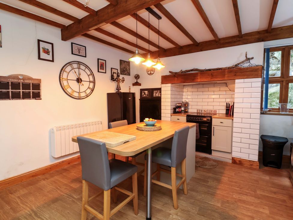 A kitchen with a table and chairs at Baywatch (St. David's View) Lynton