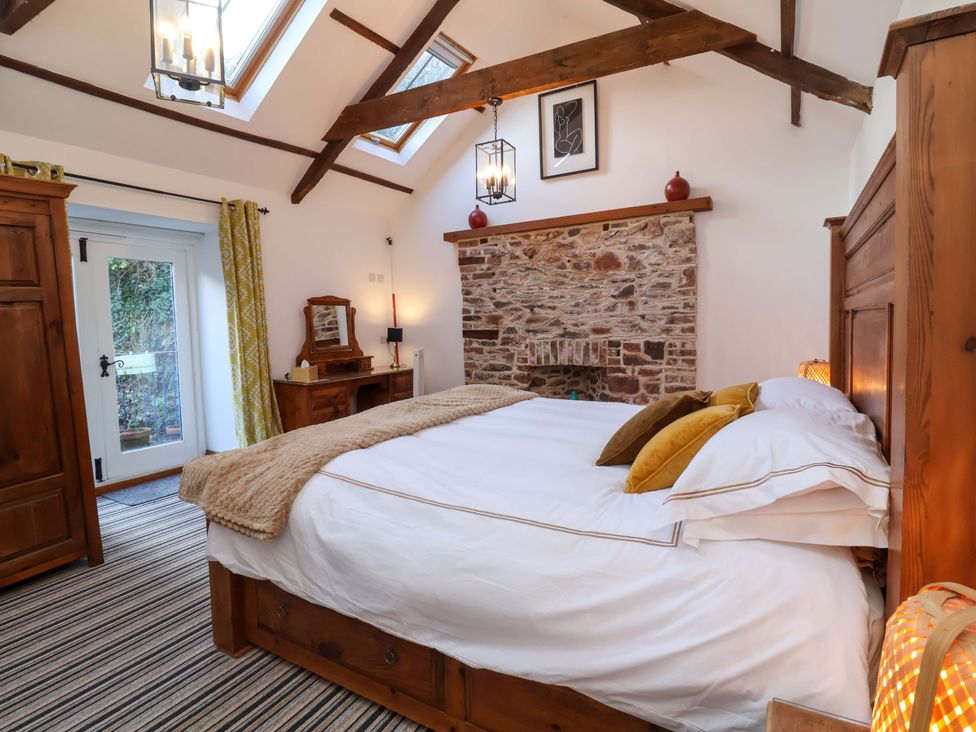 A bedroom with a bed and wardrobe at Baywatch (St. David's View) Lynton