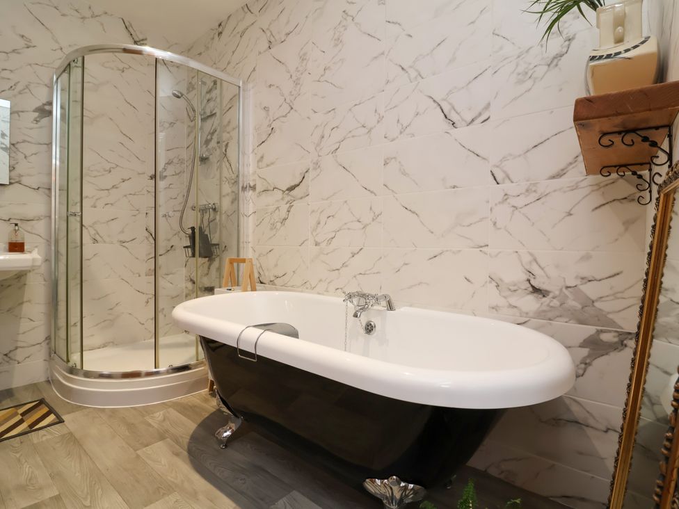 A bathroom with a shower and bathtub at Baywatch (St. David's View) Lynton