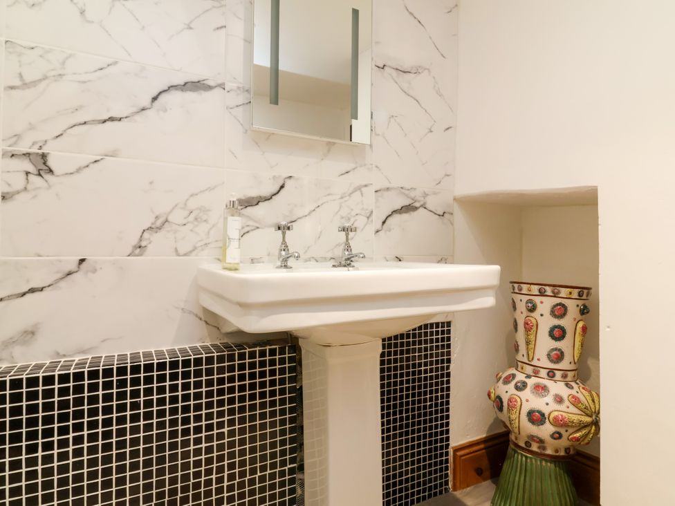 A bathroom with a sink and mirror at Baywatch (St. David's View) Lynton