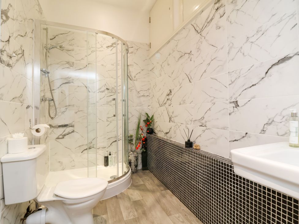 A bathroom with a shower, toilet, and sink at Baywatch (St. David's View) Lynton