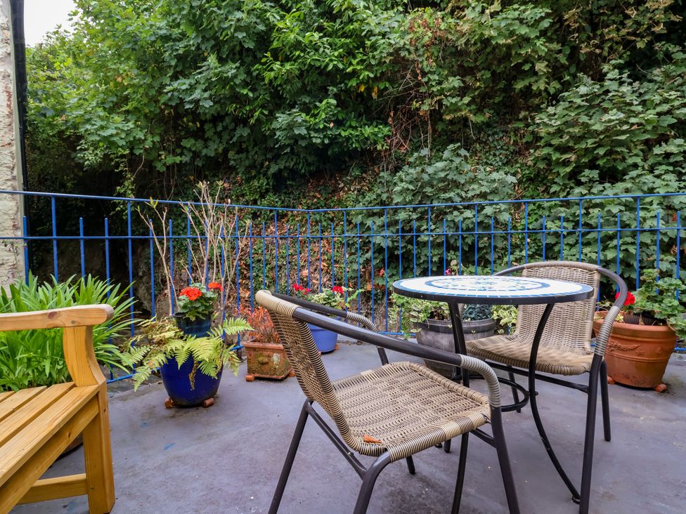 An outdoor seating area with a table and chairs at Baywatch (St. David's View) Lynton