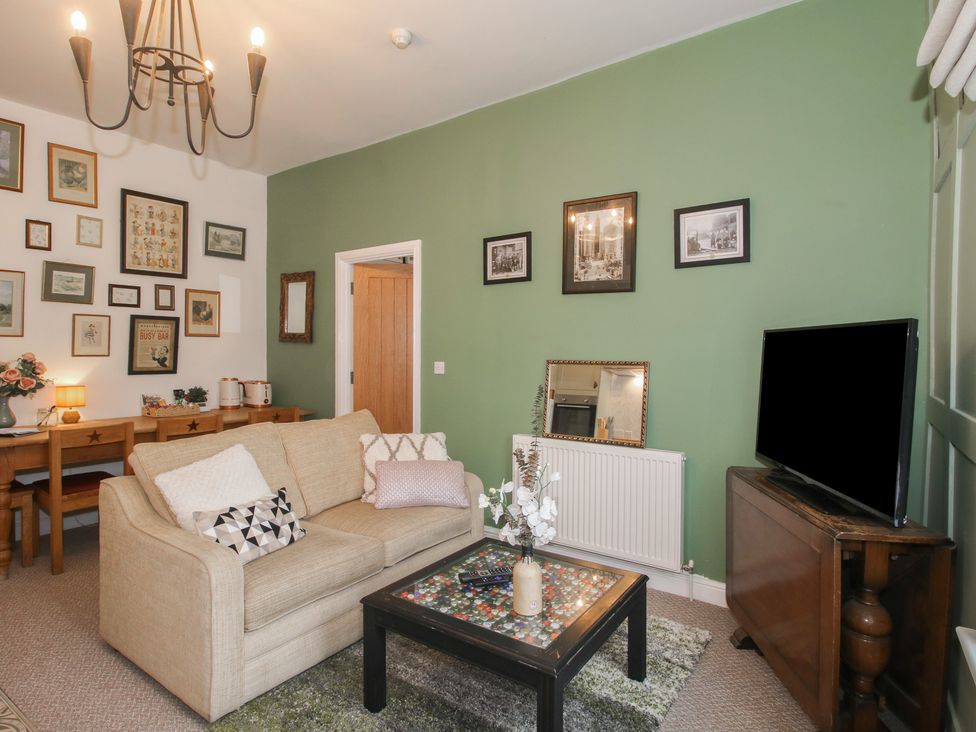 A living room with a sofa and coffee table at Apartment 2 The Bridge at Stanford Hotel near Great Witley