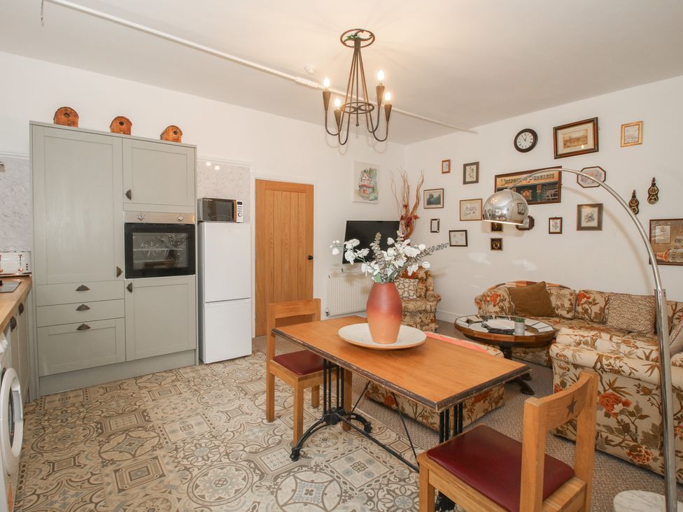 A kitchen with a dining table and chairs at Apartment 1 The Bridge at Stanford Hotel near Great Witley