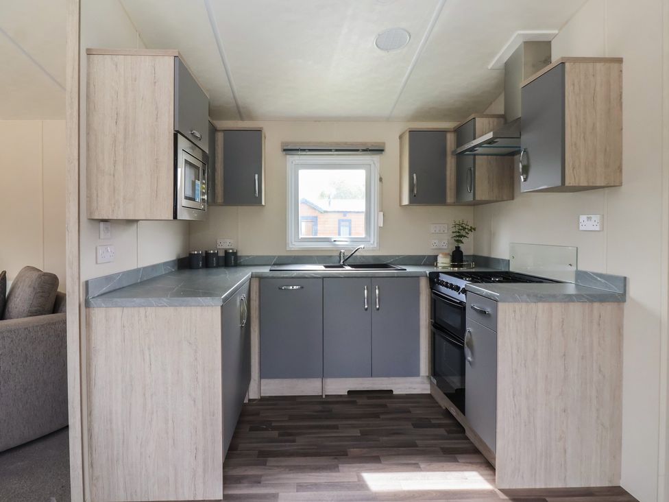 A kitchen with cabinets, sink, and appliances at Meadows Park 2 Great Hatfield near Hornsea