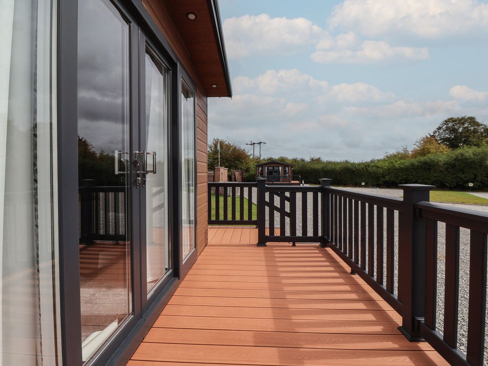 An outdoor area with glass doors and decking at Meadows Park 2 in Great Hatfield near Hornsea