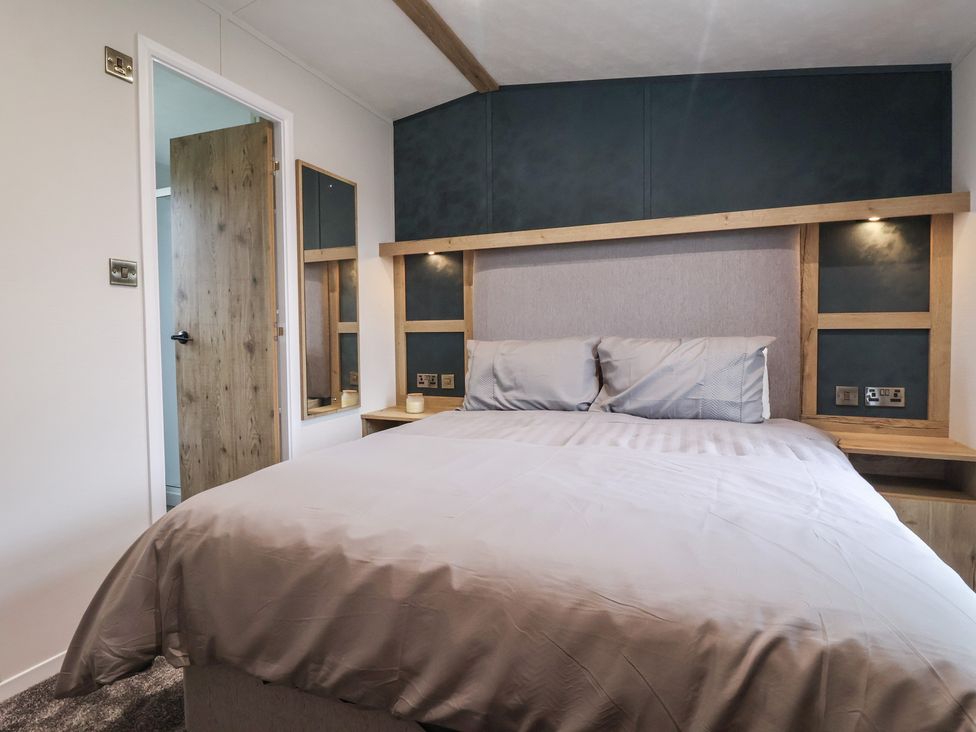 A bedroom with a bed and cupboard at Meadows Park 2 Great Hatfield near Hornsea