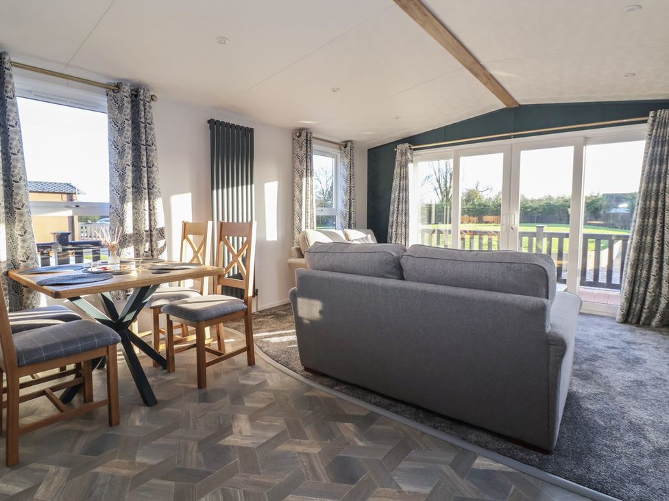 A living room featuring a table and chairs at Meadows Park 2 Great Hatfield near Hornsea