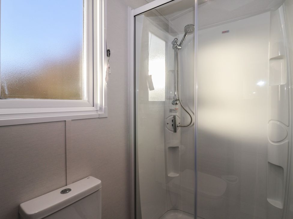 A bathroom with a shower and toilet at Meadows Park 2 Great Hatfield near Hornsea