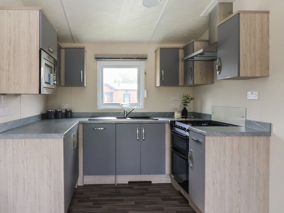 A kitchen with cabinets, sink, and oven at Meadows Park 3 Great Hatfield near Hornsea