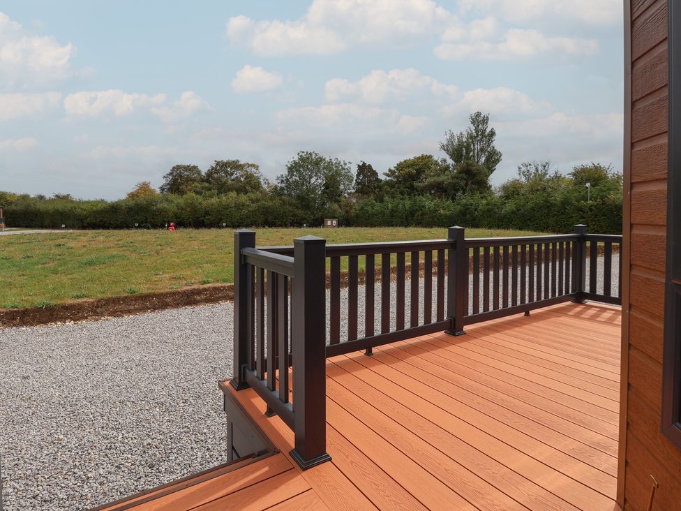 An outdoor area with decking and railing at Meadows Park 3 in Great Hatfield near Hornsea