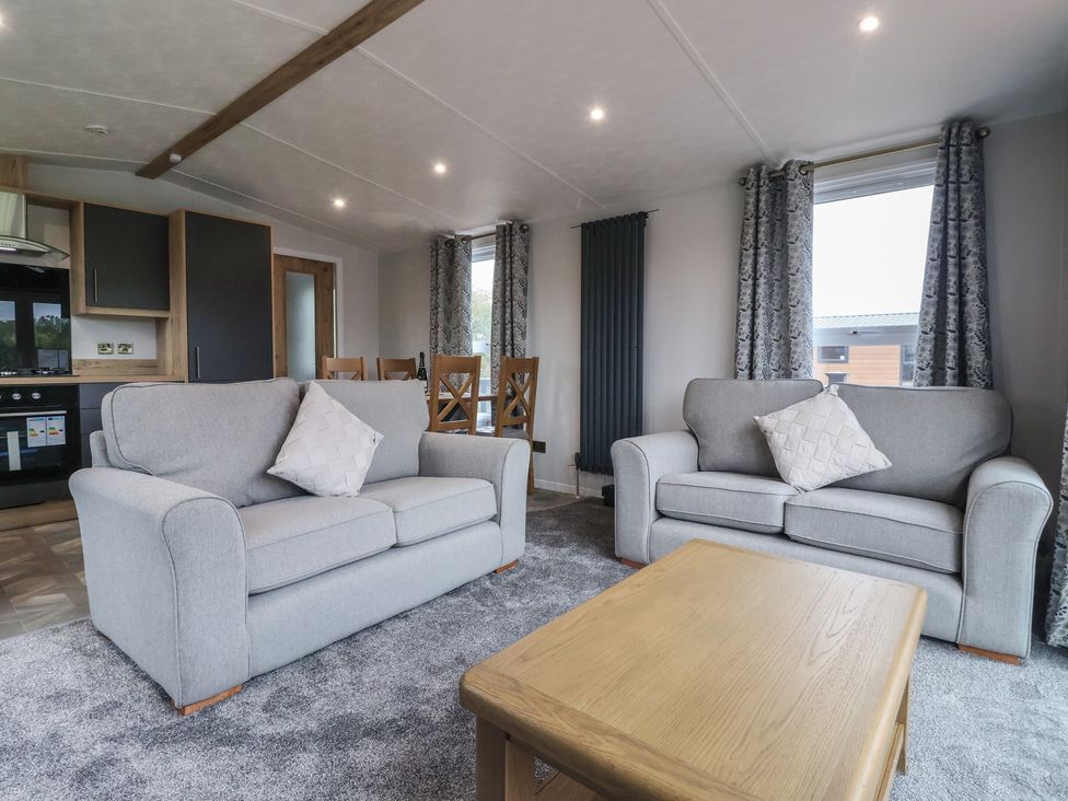A living room with couches and a table at Meadows Park 3 Great Hatfield near Hornsea