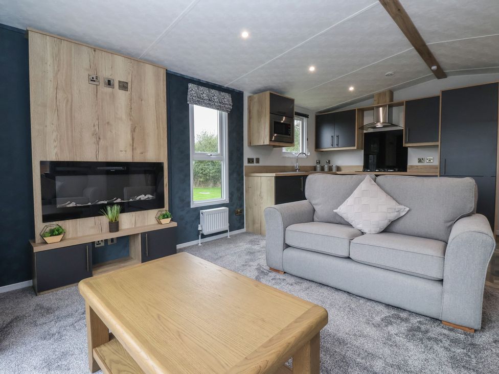 A living room with a sofa and coffee table at Meadows Park 3, Great Hatfield near Hornsea