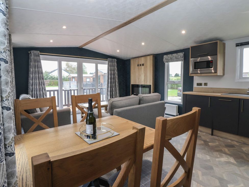 A living room with a table and sofa at Meadows Park 3 Great Hatfield near Hornsea