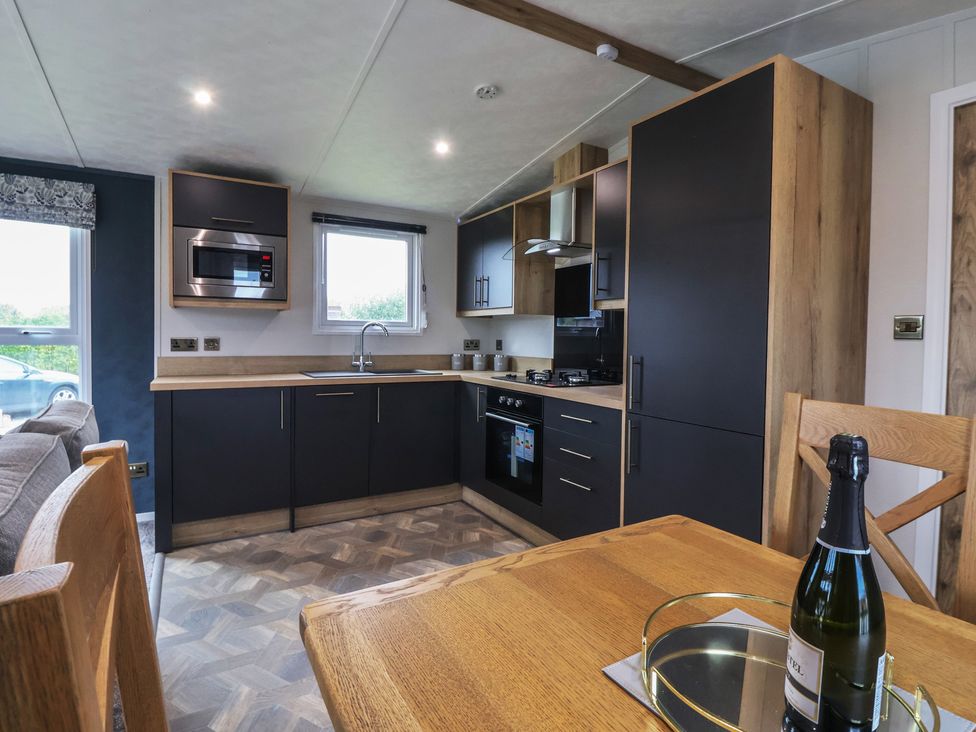 A kitchen with appliances and dining table at Meadows Park 3 Great Hatfield near Hornsea