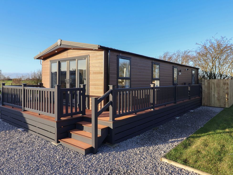 A log cabin with a deck and steps at Meadows Park 3 Great Hatfield near Hornsea