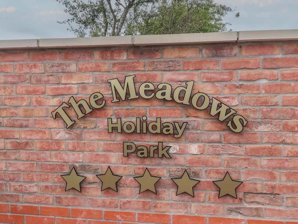A sign on a brick wall at Meadows Park in Great Hatfield near Hornsea