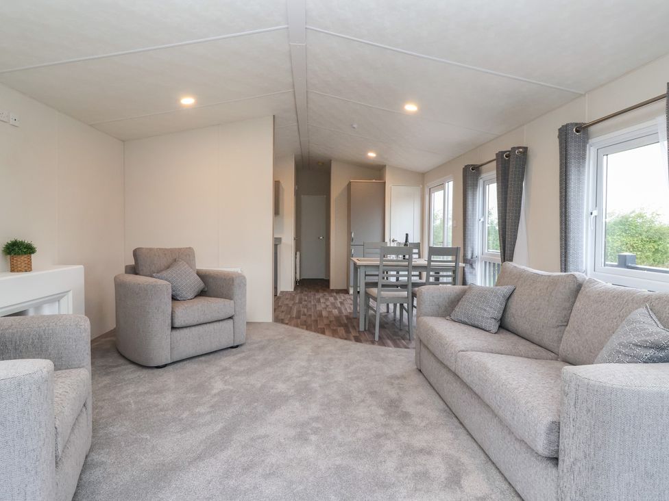 A living room with a sofa and armchairs in Meadows Park 4 Great Hatfield near Hornsea