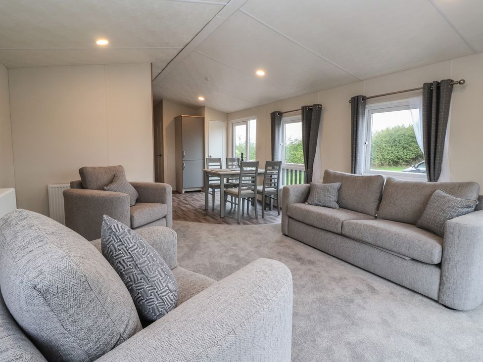 A living room with seating and dining area at Meadows Park 4 Great Hatfield near Hornsea