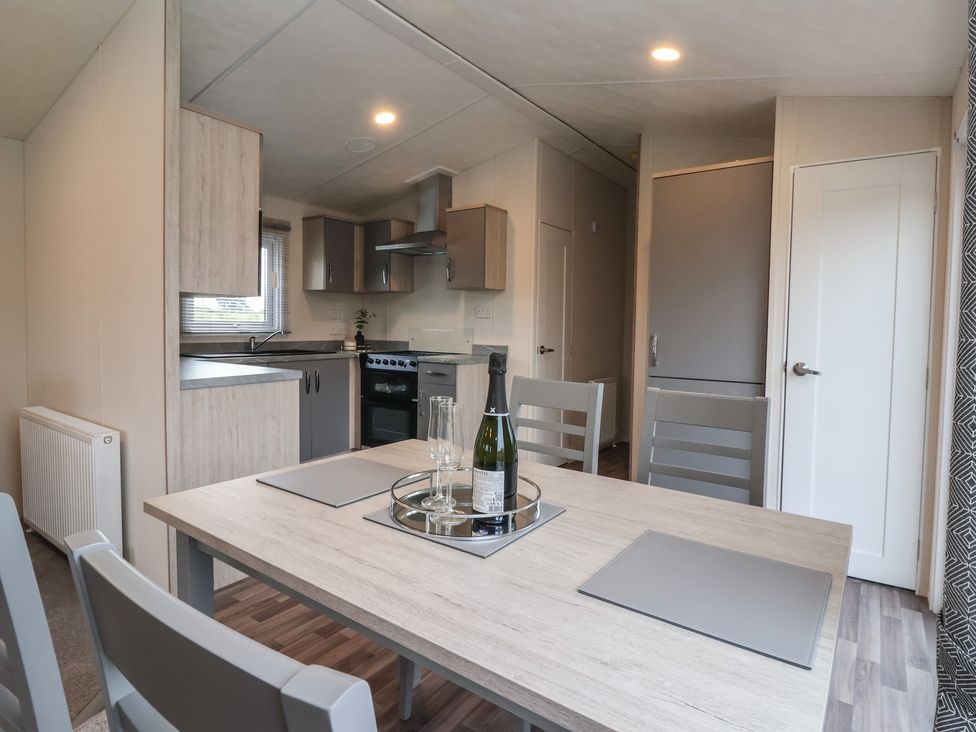 A kitchen with dining table and appliances at Meadows Park 4 Great Hatfield near Hornsea