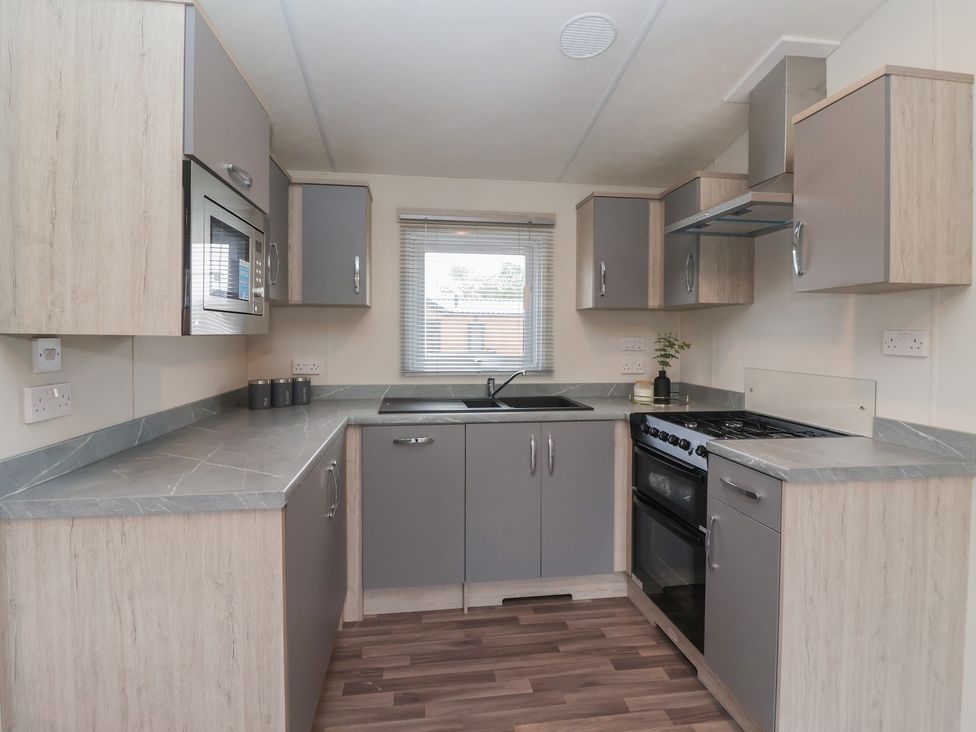 A kitchen with cabinets and appliances at Meadows Park 4, Great Hatfield near Hornsea