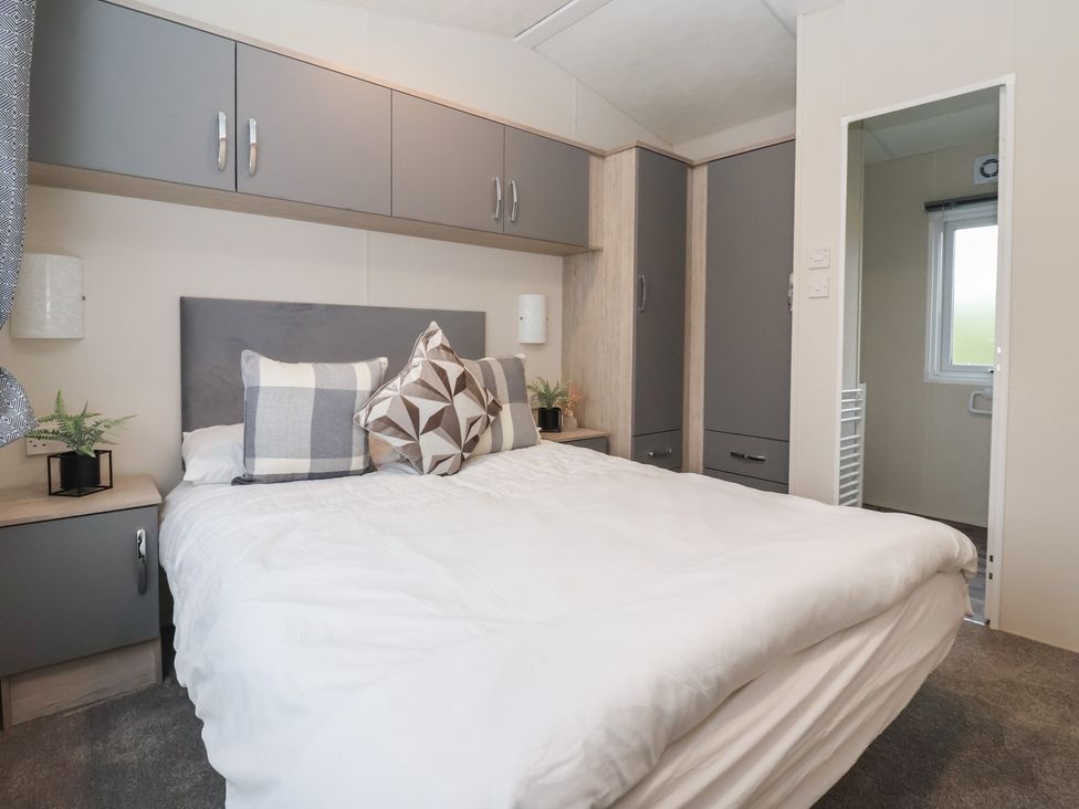 A bedroom with a bed and storage furniture at Meadows Park 4 Great Hatfield near Hornsea