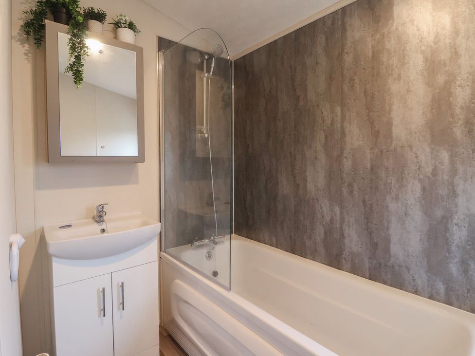 A bathroom with a bathtub and sink at Meadows Park 4 Great Hatfield near Hornsea