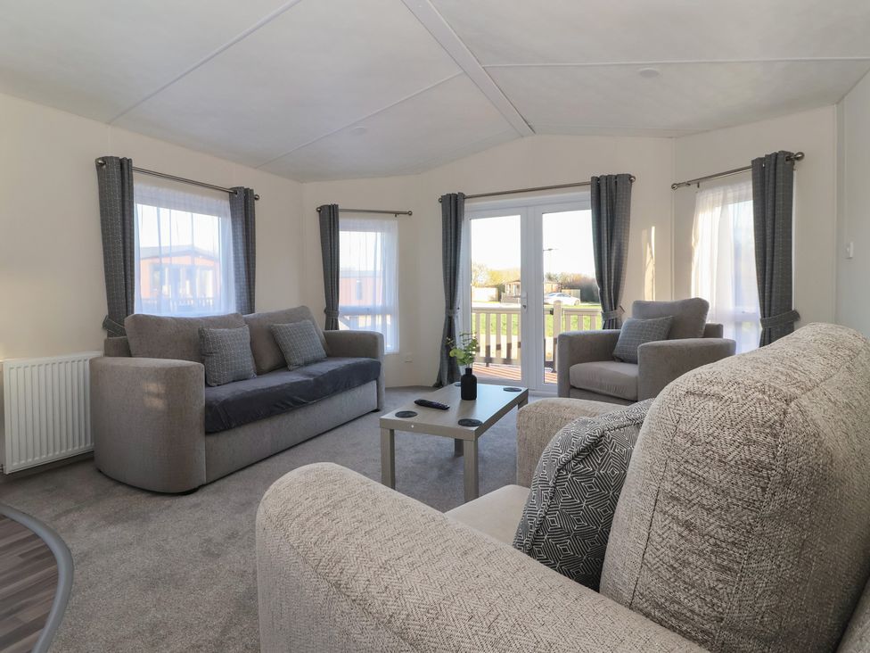 A living room with sofas and a side table at Meadows Park 4 Great Hatfield near Hornsea