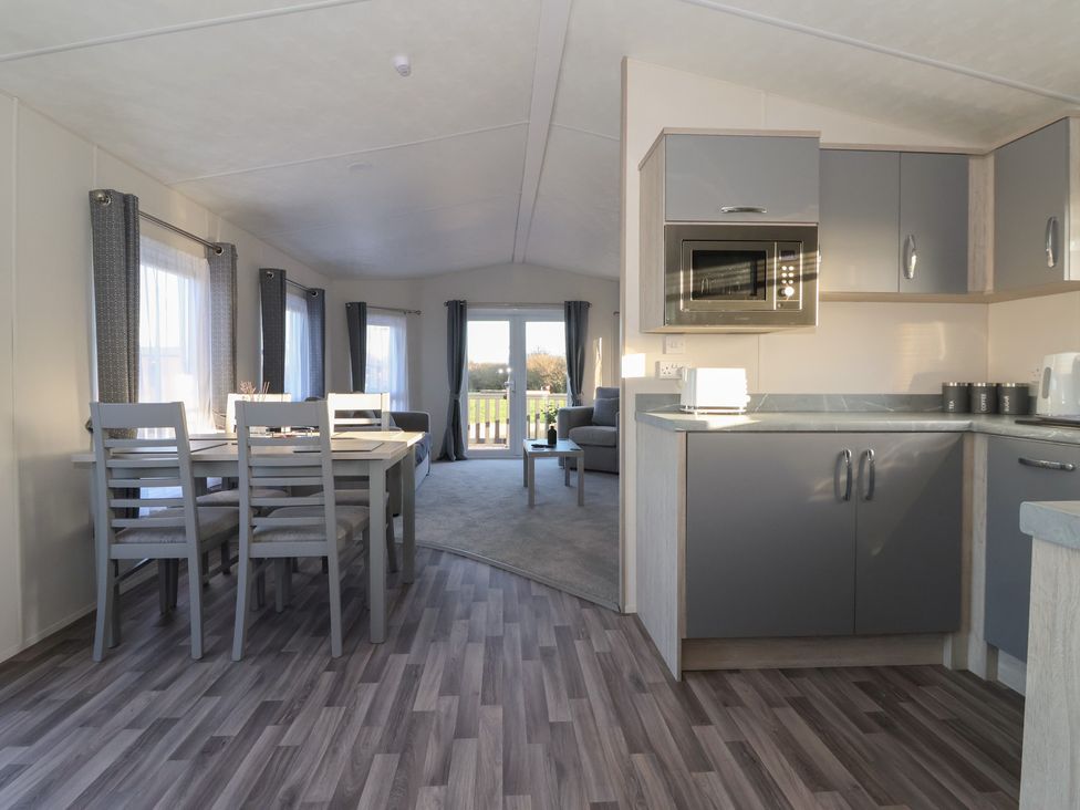 A living room and kitchen area with a table and chairs at Meadows Park 4 Great Hatfield near Hornsea