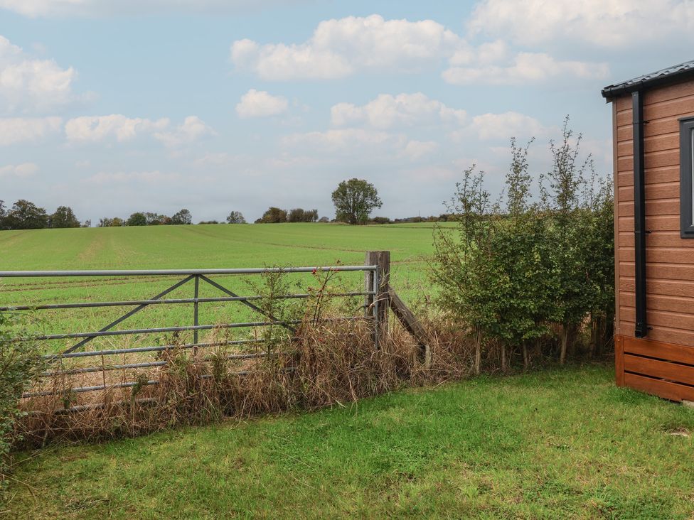 A garden with a gate and field view at Meadows Park 5 Great Hatfield near Hornsea