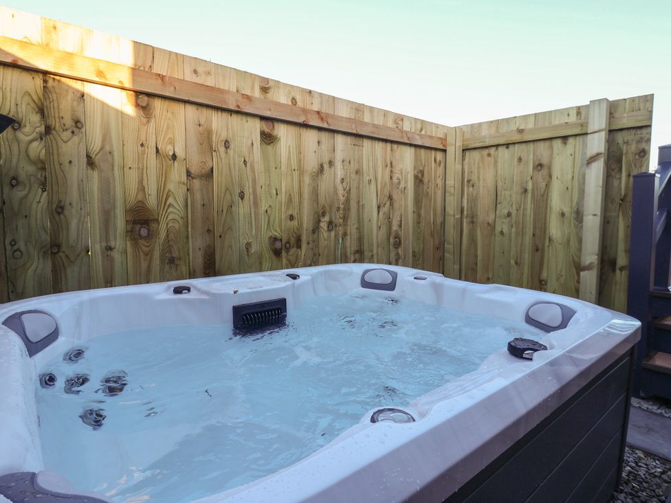 A hot tub surrounded by wooden fencing at Meadows Park 5 Great Hatfield near Hornsea