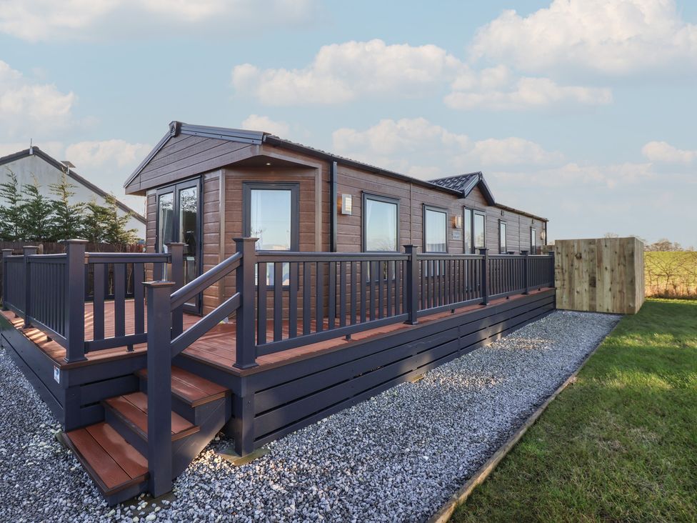 A property with a deck and railing at Meadows Park 5 in Great Hatfield near Hornsea