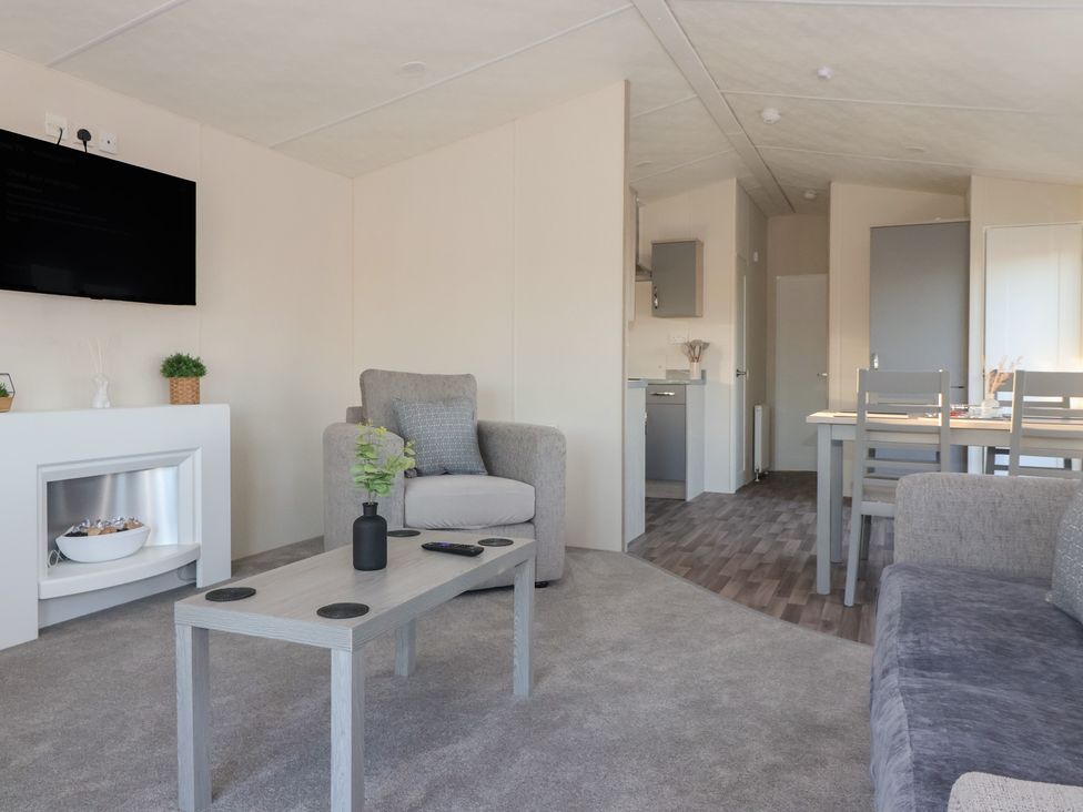 A living room with a television and sofa at Meadows Park 5 Great Hatfield near Hornsea