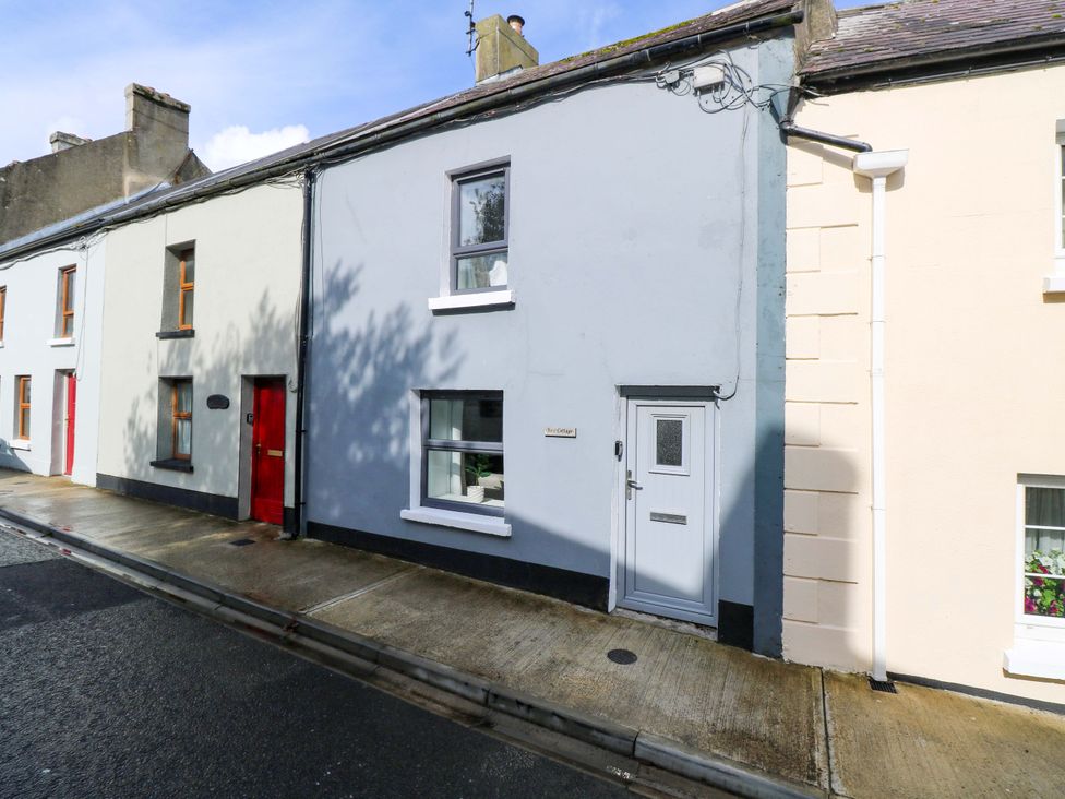 A house exterior with a sidewalk and door at Rose Cottage in Killala, County Mayo
