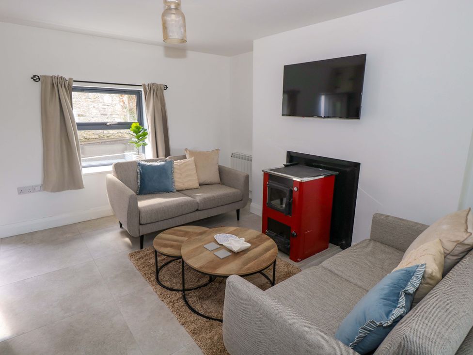 A living room with sofas and a television at Rose Cottage in Killala, County Mayo