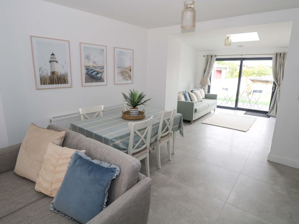 A dining area with a table and chairs at Rose Cottage, Killala, County Mayo