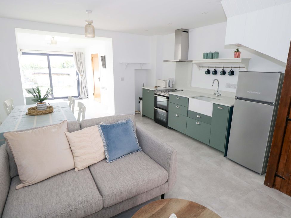 A kitchen with a sofa in Rose Cottage in Killala, County Mayo