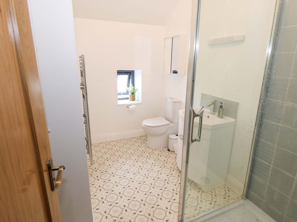A bathroom with a shower and sink at Rose Cottage Killala, County Mayo