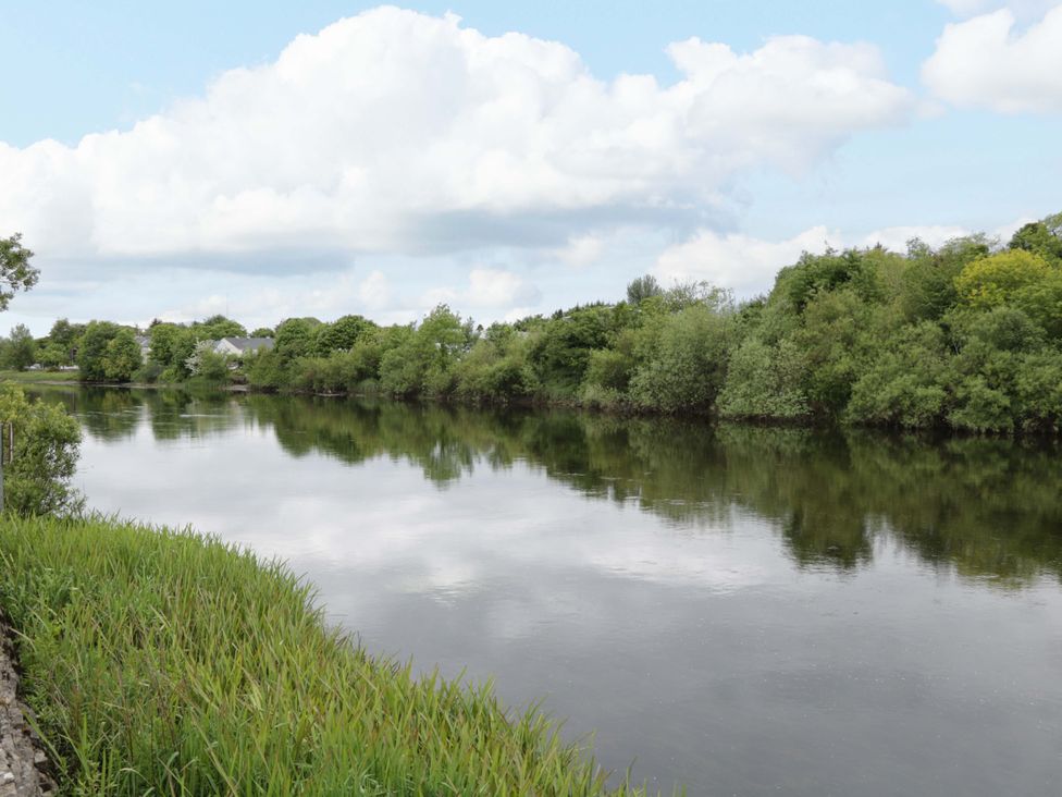 A river surrounded by trees and grass at Rose Cottage in Killala, County Mayo