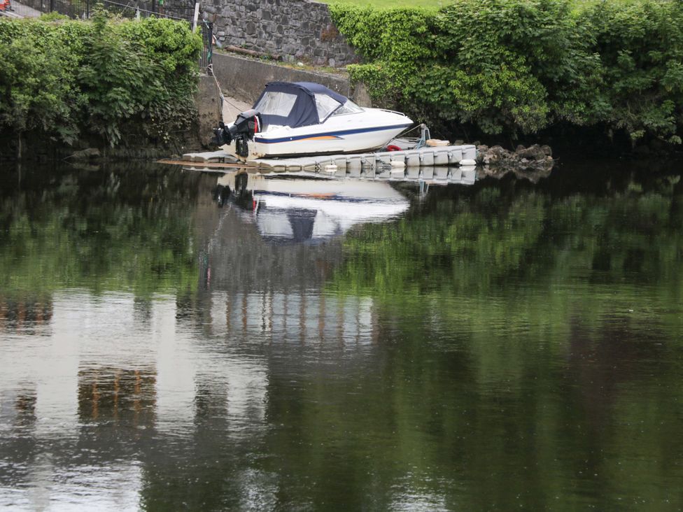 A boat on water with reflection at Rose Cottage in Killala, County Mayo