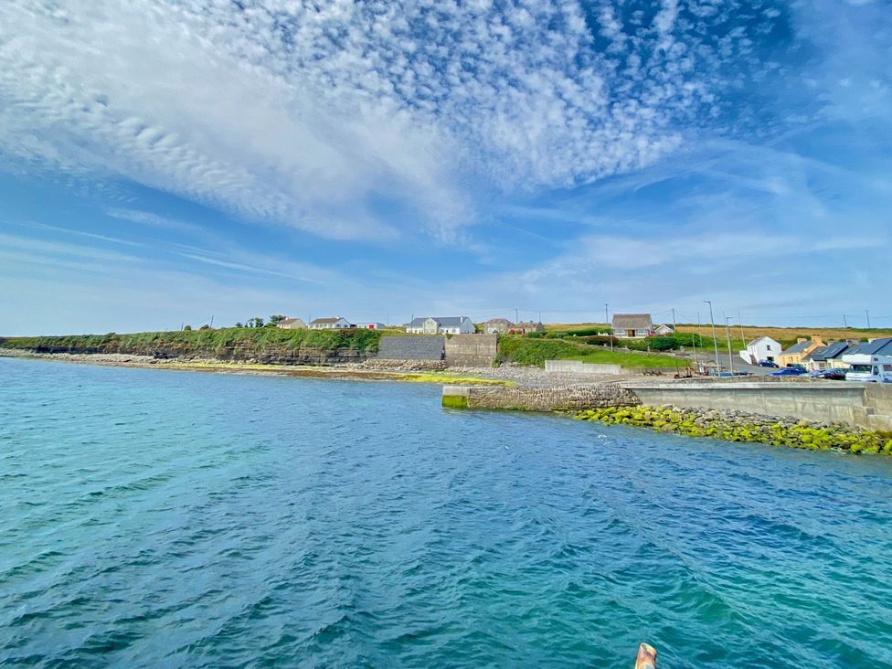 A coastal view with buildings along the shore at Rose Cottage in Killala, County Mayo