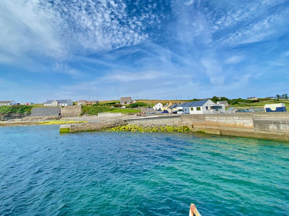 A scenic view of a coastal area with houses and a pier at Rose Cottage, Killala, County Mayo