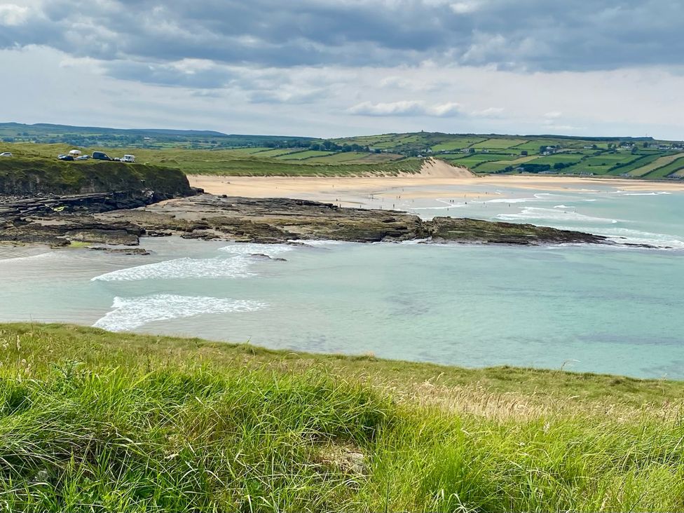 A beach with cliffs and water at Rose Cottage in Killala, County Mayo