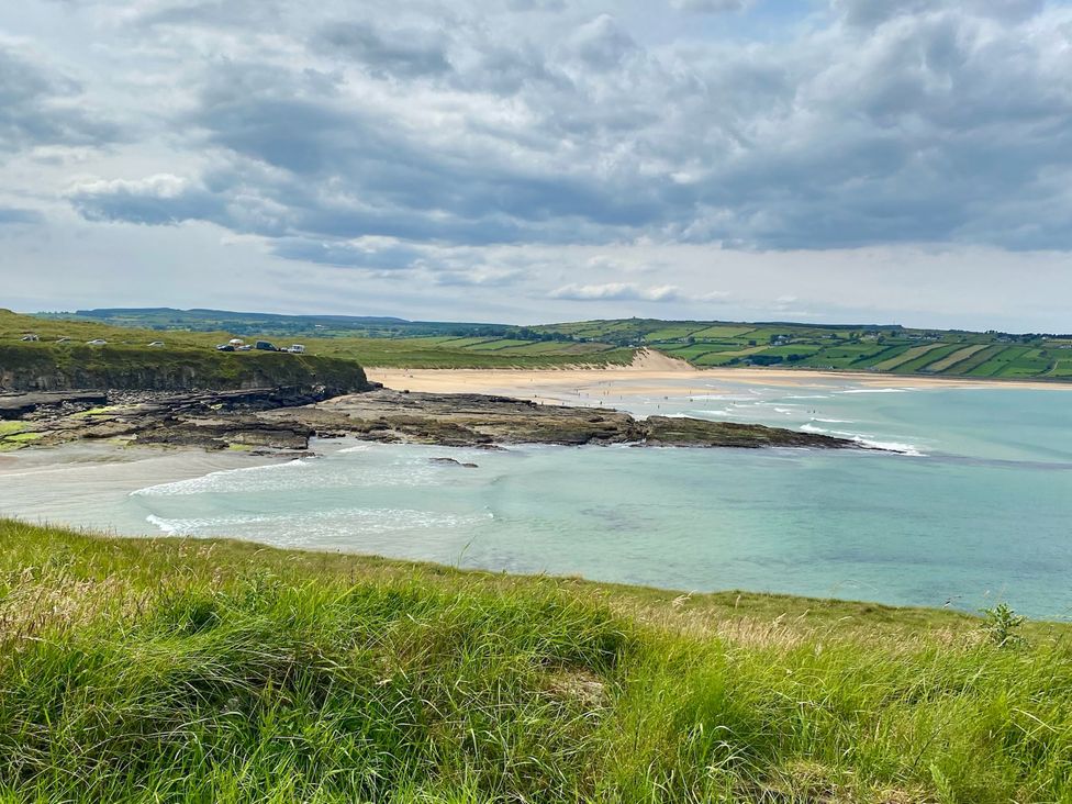 A beach with rocks and hills near the ocean at Rose Cottage, Killala, County Mayo
