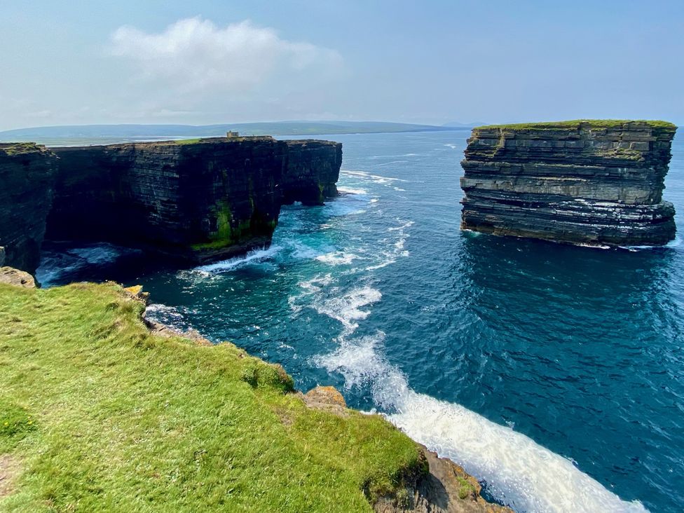 Cliffs by the ocean with waves at the Cliffs of Moher in County Clare